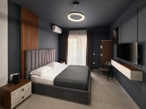 a bedroom with a bed and a flat screen tv at Tirana days Free Parking in Tirana