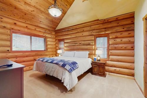 a bedroom with a bed in a log cabin at The Dockside Gamehouse in Olympia