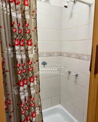 a bathroom with a shower curtain and a tub at Costa Azul 2 in Villa Pehuenia