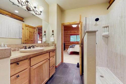 a bathroom with a sink and a mirror and a bedroom at The Dockside Gamehouse in Olympia