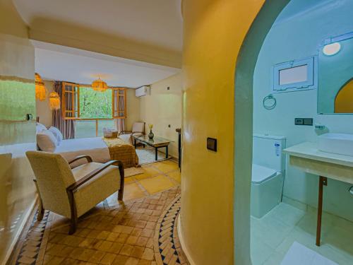 a hotel room with a bed and a bathroom at Targa Imoula Luxe in Imlil