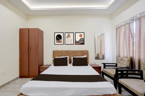a bedroom with a large bed and a chair at Hotel O Rajdhani Heritage in Nāmkom