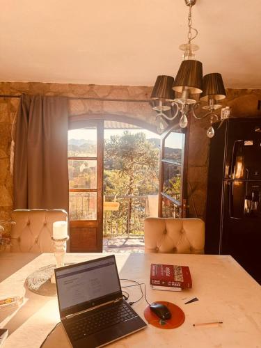 a laptop computer sitting on top of a table at Posada Bella Vista 1 y 2 in El Volcán