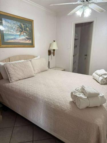 a bedroom with a large bed with towels on it at Ocean View - Hot Tubs - Heated Pool - Gym - Tennis ct - Shoreline Stays 22 in Galveston