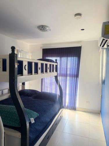 a bedroom with a bunk bed with blue sheets at Playa dorodo in La Chorrera