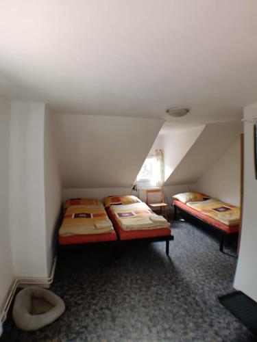 a room with two beds in a attic at Chata Florian in Adolfov