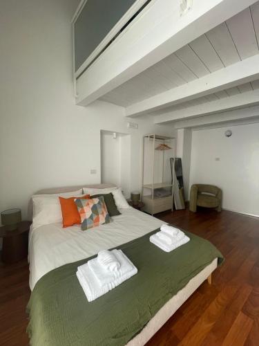 a bedroom with a large bed with towels on it at Boemondo 33 in Bari