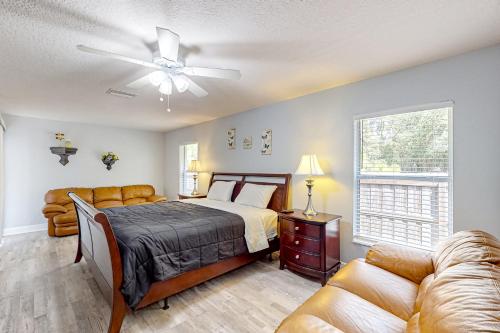 a bedroom with a bed and a ceiling fan at Poolside Oasis! Family-Friendly Summerfield Escape in Orange Blossom Hills