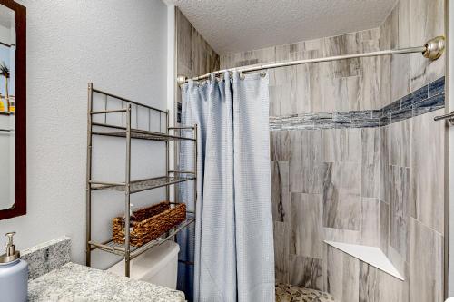 a bathroom with a shower with a shower curtain at Poolside Oasis! Family-Friendly Summerfield Escape in Orange Blossom Hills