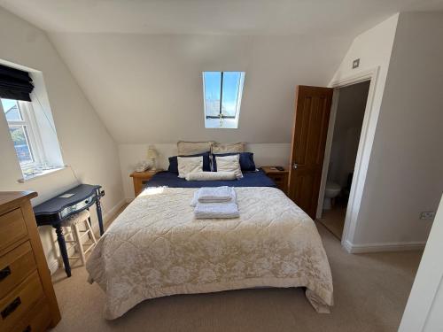 a bedroom with a bed and a desk and a sink at Silsoe B&B Master Suite in Silsoe