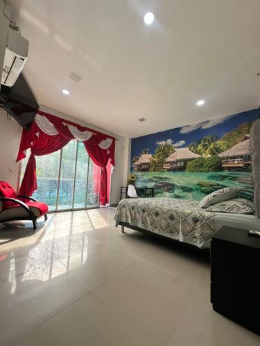 a bedroom with a bed and a painting on the wall at APARTAMENTO CONFORTABLe 200 in Arauca