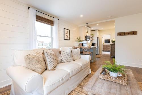 a white couch in a living room with a kitchen at Kildahl House - Boutique Farmhouse Suite #4 in West Dundee