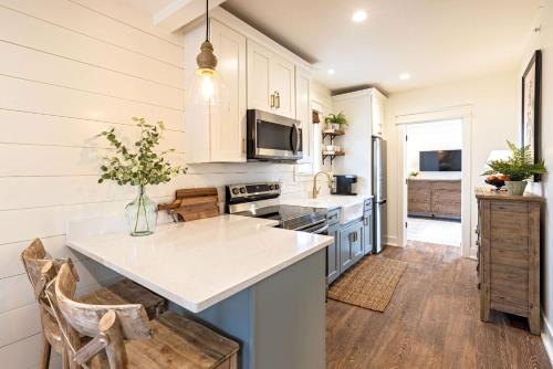 a kitchen with white cabinets and a counter top at Kildahl House - Boutique Farmhouse Suite #4 in West Dundee
