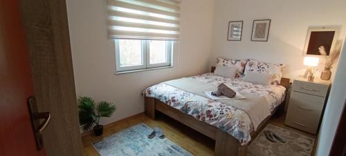 a small bedroom with a bed and a window at Zagrljaj prirode in Blagaj
