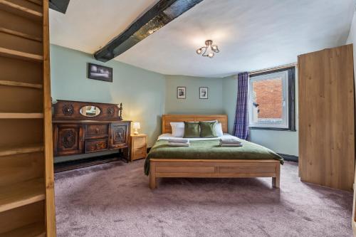 a bedroom with a bed and a ladder and a window at 2BR House with WiFi - Sleeps 5 - Gloucester in Gloucestershire