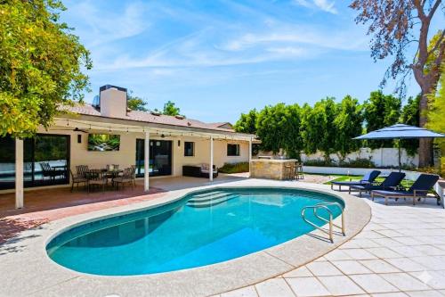 a swimming pool with a patio and a house at Chaparral Dog Park & Lake, Heated Pool, Pets Allowed in Scottsdale