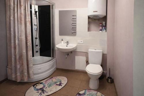a bathroom with a toilet and a sink at Apartamenti dzīvoklis Ogre. in Ogre