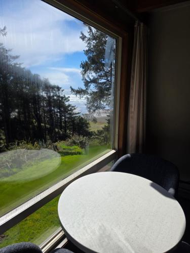 a table and chairs in front of a window at Ocean Crest Resort in Moclips