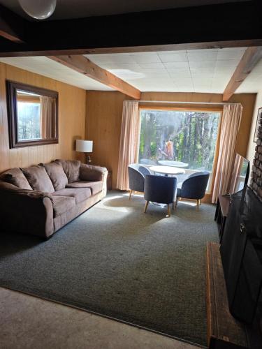 a living room with a couch and a table at Ocean Crest Resort in Moclips