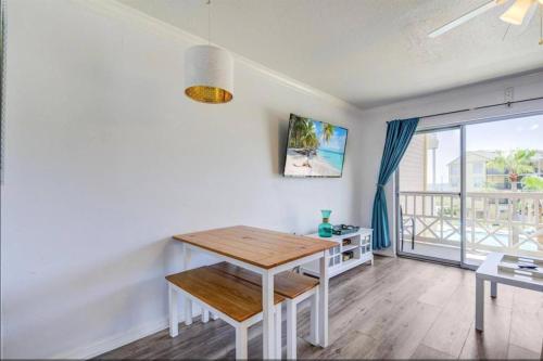 a dining room with a table and a balcony at Ocean & Pool View - Hot Tub - 2 Pools - Gym - Tennis ct - Shoreline Stays 10 in Galveston