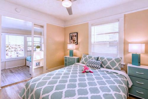 a bedroom with a bed with a pink stuffed animal on it at CasaViva Vista - Top-Floor 2BR with Private Porch, City Views & Sunset, Walk to Hillcrest, Near Zoo & Beaches, San Diego in San Diego