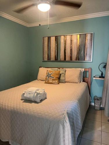 a bedroom with a bed with a towel on it at Ocean Views - Heated Pool - Hot Tub - Corner Unit - steps to beach - SS 29 in Galveston