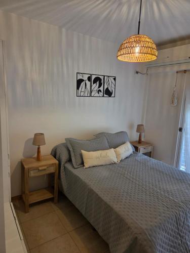 a bedroom with a bed and a chandelier at Olivos Calm Stay in Olivos