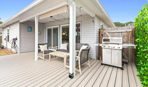 a patio with a table and chairs on a deck at New Home with Fenced Yard Large Deck & Fire Pit in Navarre