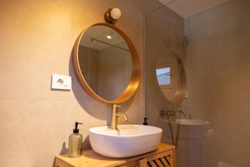 a bathroom with a sink and a mirror at Watan A&D in Buna