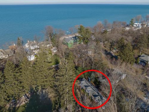 an aerial view of a house on a hill next to the water at The Songbird by Juniper Holiday + Home in New Buffalo