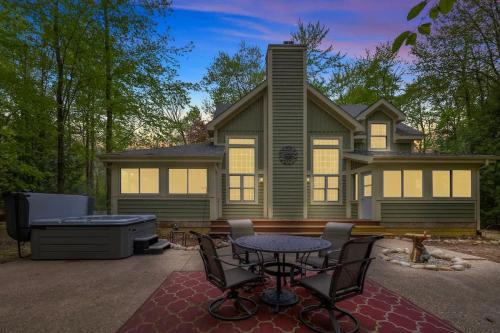 a house with a backyard with a grill and a table and chairs at Pete's Place by Juniper Holiday + Home in Sawyer