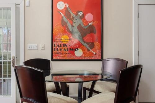 a dining room with a table and chairs and a poster at Pete's Place by Juniper Holiday + Home in Sawyer