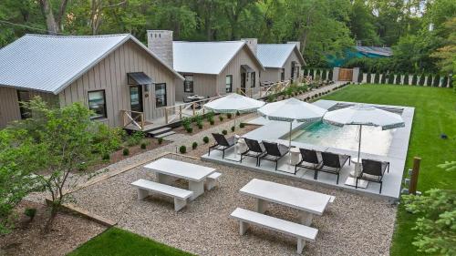 an aerial view of a patio with tables and umbrellas at Townie 2 - The Sage by Juniper Holiday + Home Unit in Union Pier