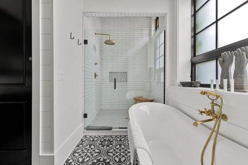 a white bathroom with a tub and a shower at Black Door Bungalow by Juniper Holiday + Home in Lakeside