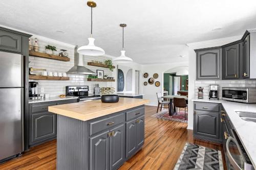 a kitchen with gray cabinets and a kitchen island at The Birdcage by Juniper Holiday + Home in Douglas