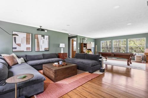 a living room with a couch and a piano at The Birdcage by Juniper Holiday + Home in Douglas
