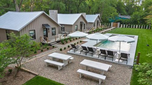 an aerial view of a backyard with tables and umbrellas at Townie 3 - The Moss by Juniper Holiday + Home in Union Pier