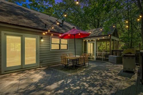 a patio with a table and an umbrella on a house at The High Life by Juniper Holiday + Home in New Buffalo