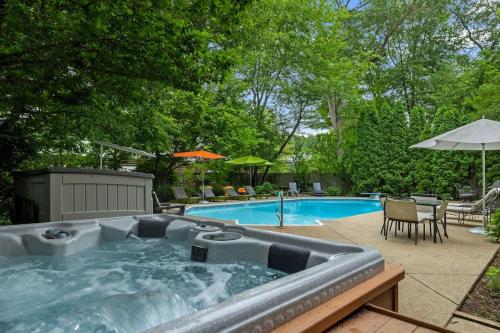a swimming pool with a hot tub in a backyard at Casa Azur by Juniper Holiday + Home in Union Pier