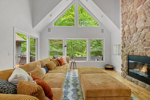 a living room with a couch and a fireplace at Gray Haven by Juniper Holiday + Home in Union Pier