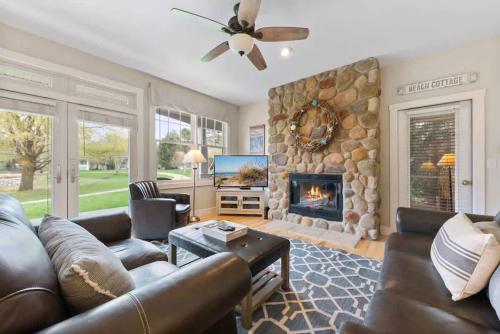 a living room with a couch and a fireplace at Schoolhouse Rock by Juniper Holiday + Home in New Buffalo