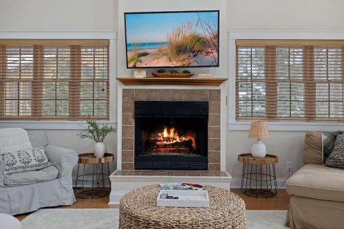 a living room with a fireplace with a tv at Deer Haus by Juniper Holiday + Home in New Buffalo