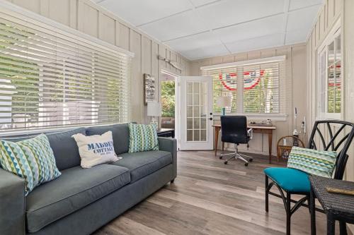 a living room with a couch and a table and chairs at Whispering Arbor by Juniper Holiday + Home in Lakeside
