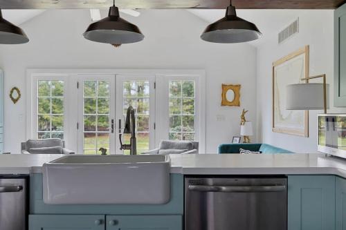 a kitchen with a sink and some windows at Rabbit Run by Juniper Holiday + Home in Sawyer