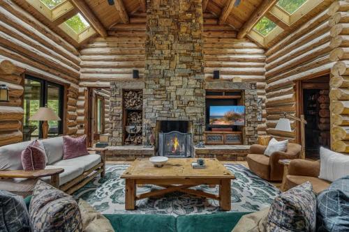 a living room with a fireplace in a log cabin at Wilder Woods in Michiana