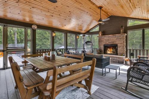 a living room with a table and a fireplace at Hearth & Timber in Bridgman