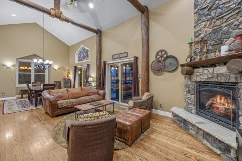 a living room with a fireplace and a couch at Lodged in the Trees in New Buffalo