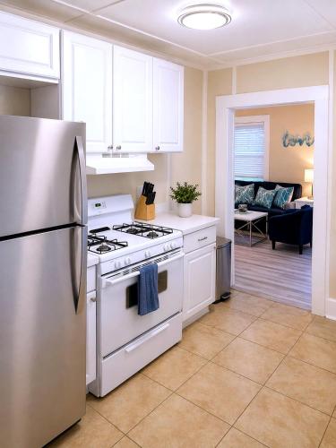 a kitchen with a stove and a refrigerator at CasaViva Play - 3BR 1BA, Private Deck & City Views, Firepit, Kids Playset - Walk to Hillcrest & North Park, Near Zoo, SeaWorld & Beaches in San Diego