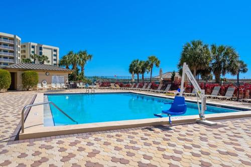 a blue chair sitting next to a swimming pool at Condo in oceanfront complex with pools private beach access and balcony in Destin