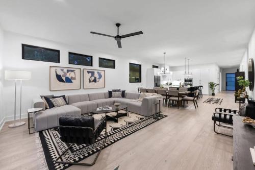 a living room with a couch and a dining room at Stylish Southern Home with Heated Pool in Austin